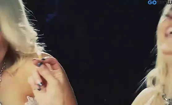 The enticing blonde smokes and teases her lover with leg exposure and tantalizing touches, arousing desire and anticipation